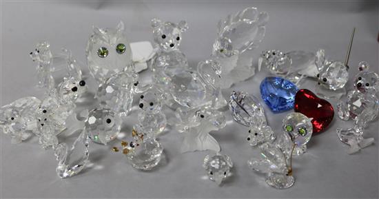 A collection of 24 Swarovski crystal animals, including owls, teddy bears, ducks, etc.,